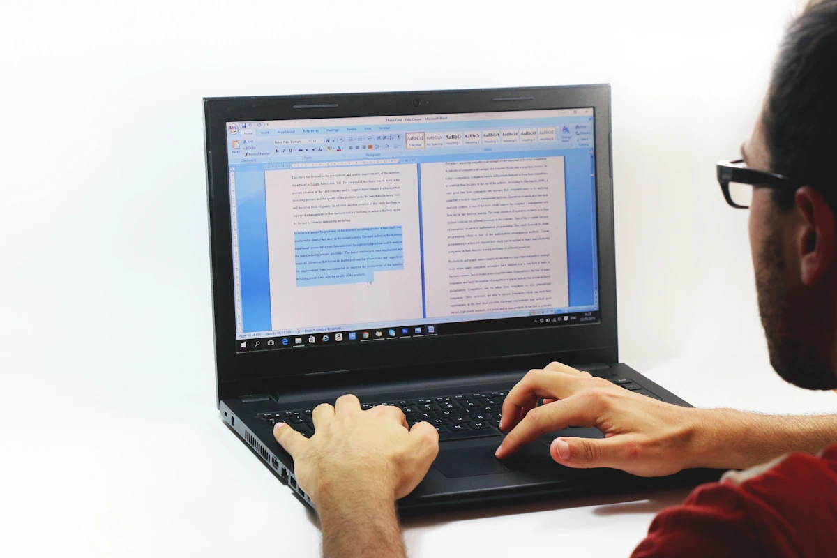 Un homme qui rédige un article sur un ordinateur